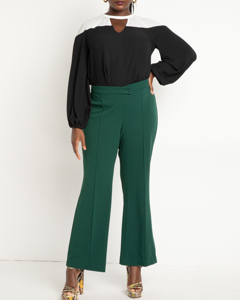 Front of a model wearing a size 24 Overlap Waist Flare Leg Pant in Dark Green by ELOQUII. | dia_product_style_image_id:272927